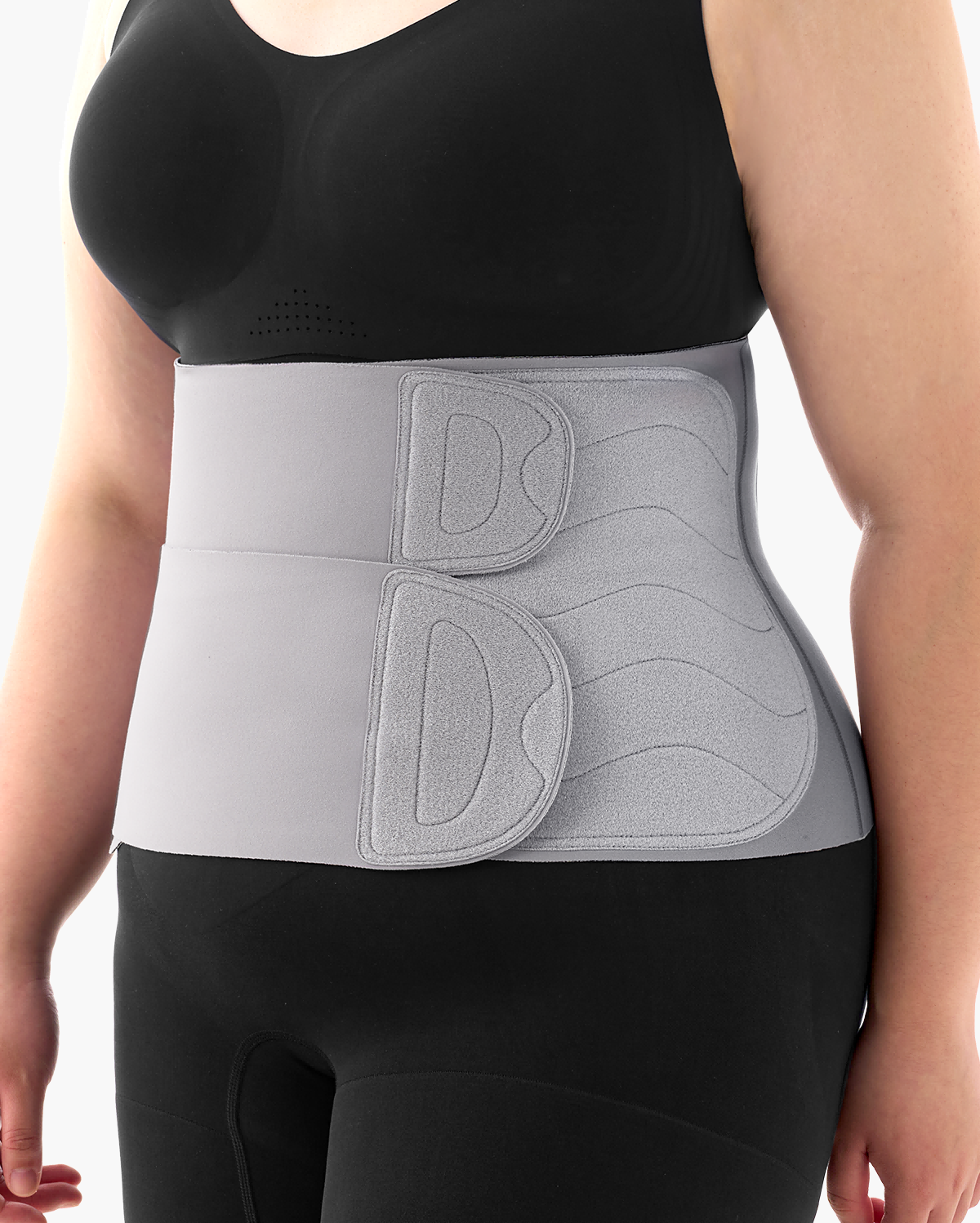 Momcozy Ergowrap Postpartum Belly Band in light gray, worn by a woman for postpartum support