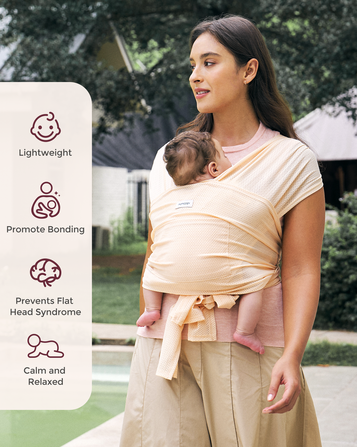 Momcozy peach baby wrap carrier, hands-free babywearing, promoting bonding, lightweight design for baby's comfort