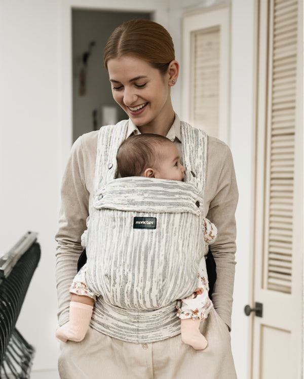 Momcozy PureHug baby carrier in striped design. Mother babywearing with newborn, comfortable and stylish.