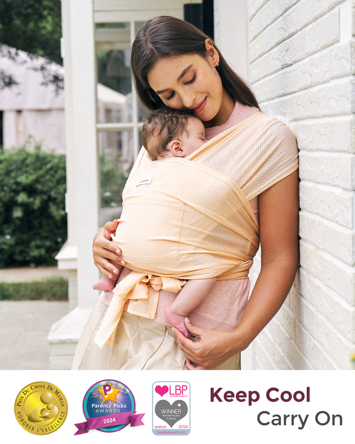 Momcozy peach baby wrap carrier, hands-free design for comfortable babywearing. Promotes bonding and keeps baby cool.
