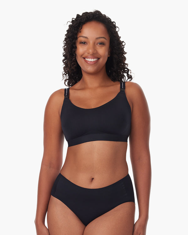 Woman wearing black Momcozy nursing bra, highlighting support and comfort for breastfeeding.