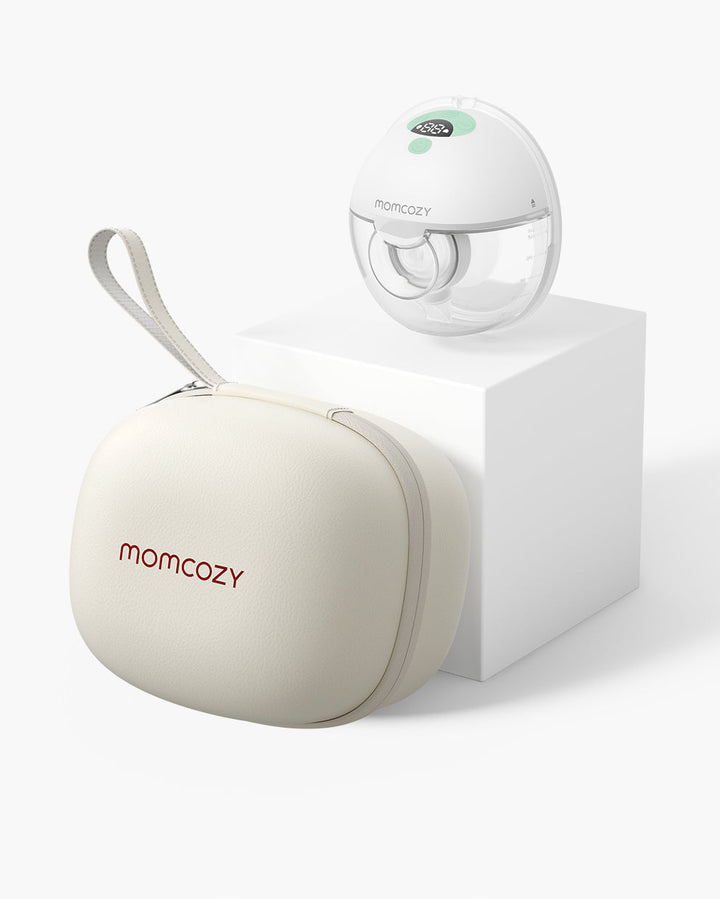 All-in-one M5 Wearable Breast Pump by Momcozy with beige carrying case and white platform