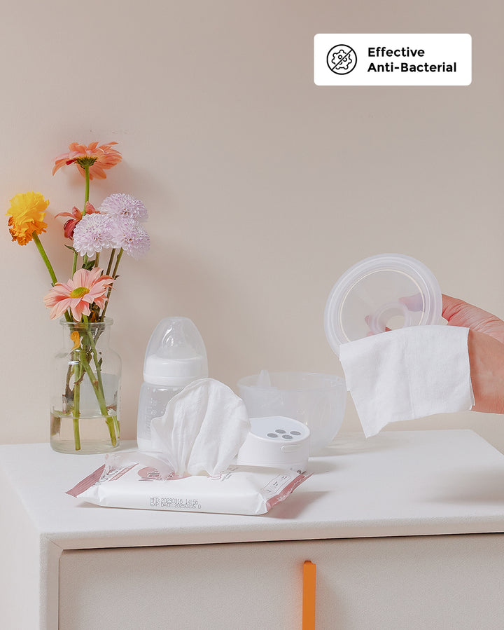 Momcozy Natural Breast Pump Wipes, 90 count, with flowers and a breast pump kit.