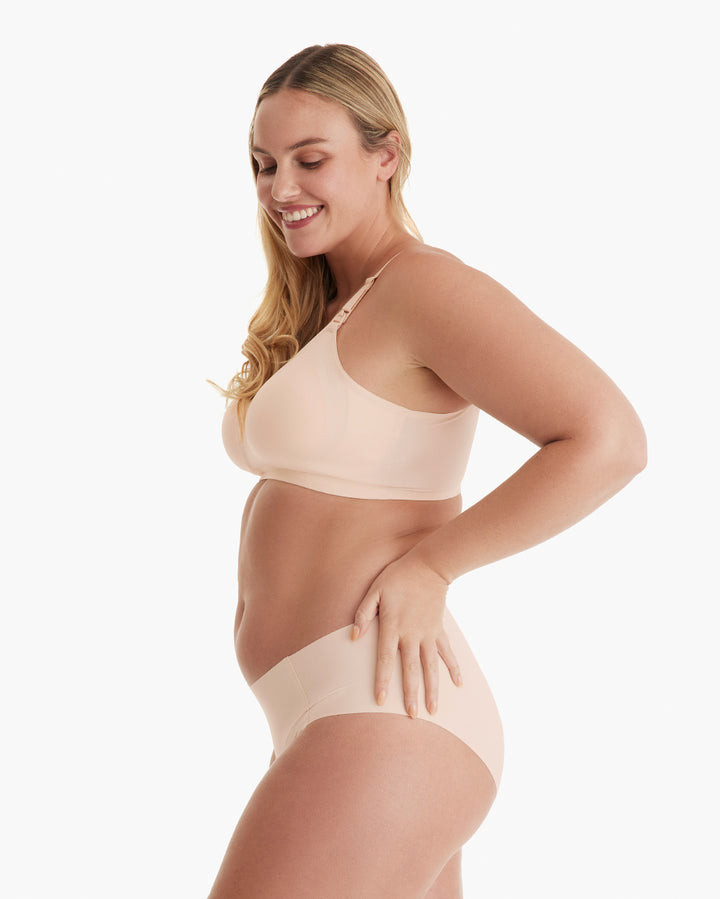 Smiling model wearing light peach Ultra Soft Seamless Nursing Bra YN21 & briefs, showcasing smooth fabric & flattering fit.