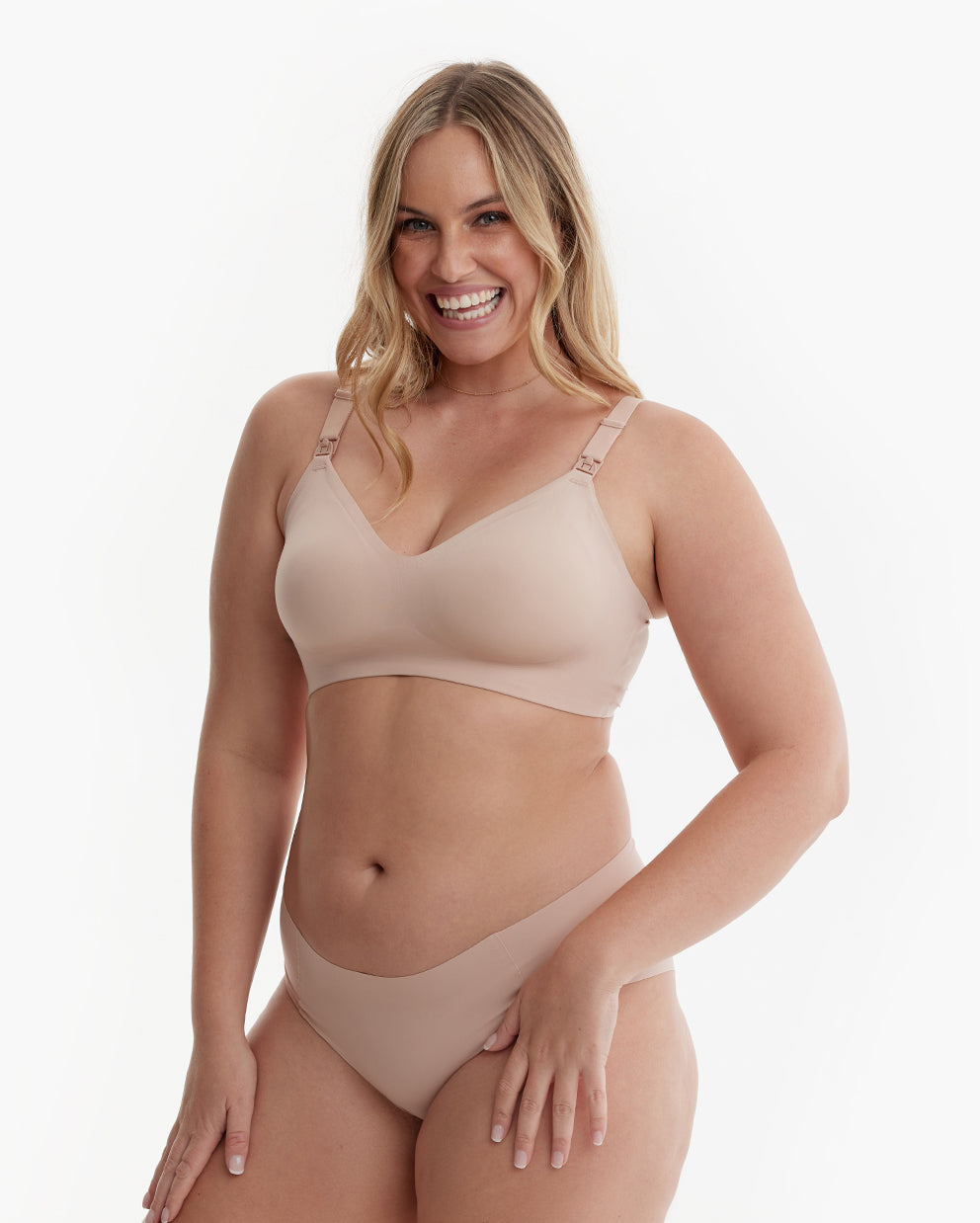 Smiling woman in nude Ultra Soft Seamless Nursing Bra YN21, showcasing flattering fit, smooth V-neck & M5 pump clips.
